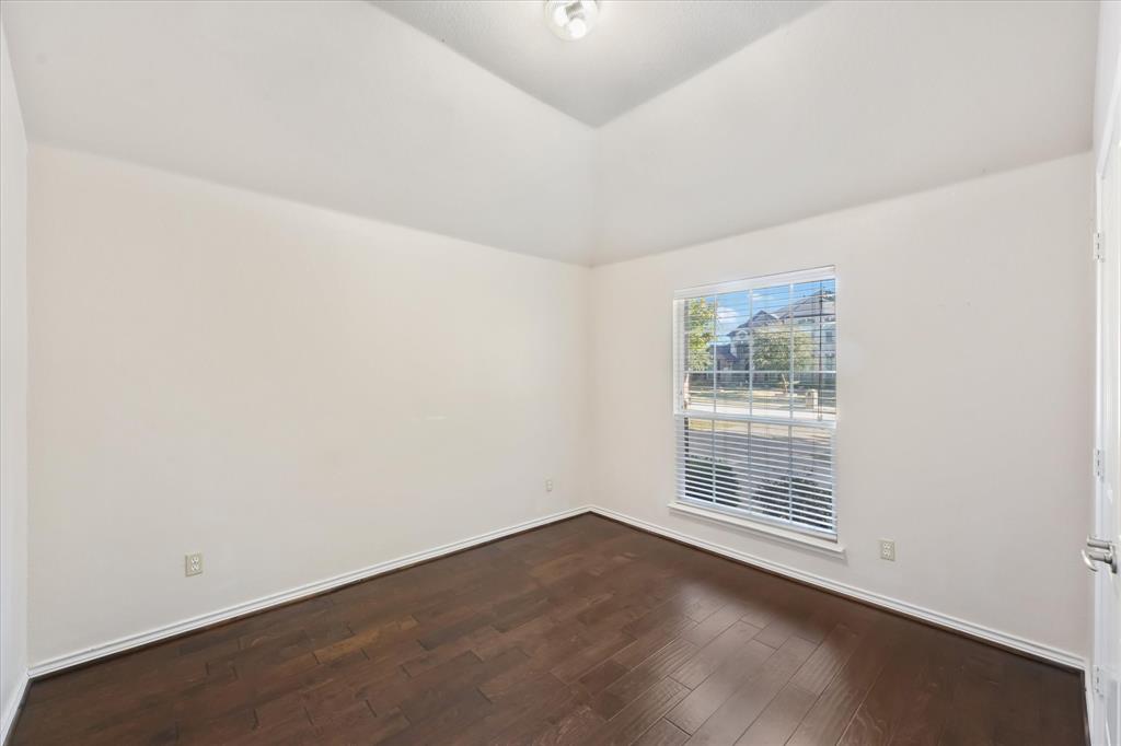 12811 Greenhaven Drive Frisco, TX 75035 - Photo 23 of 28 an empty room with wooden floor and windows