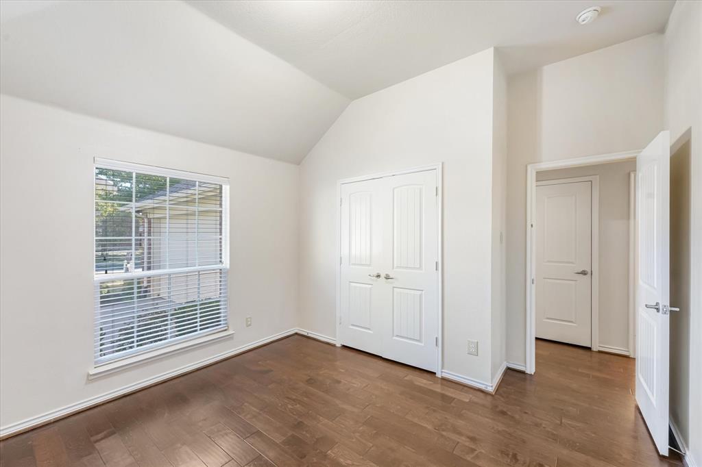 12811 Greenhaven Drive Frisco, TX 75035 - Photo 24 of 28 a view of an empty room with wooden floor and a window