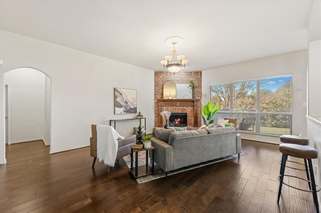 12811 Greenhaven Drive Frisco, TX 75035 - Photo 7 of 28 a living room with furniture and a fireplace