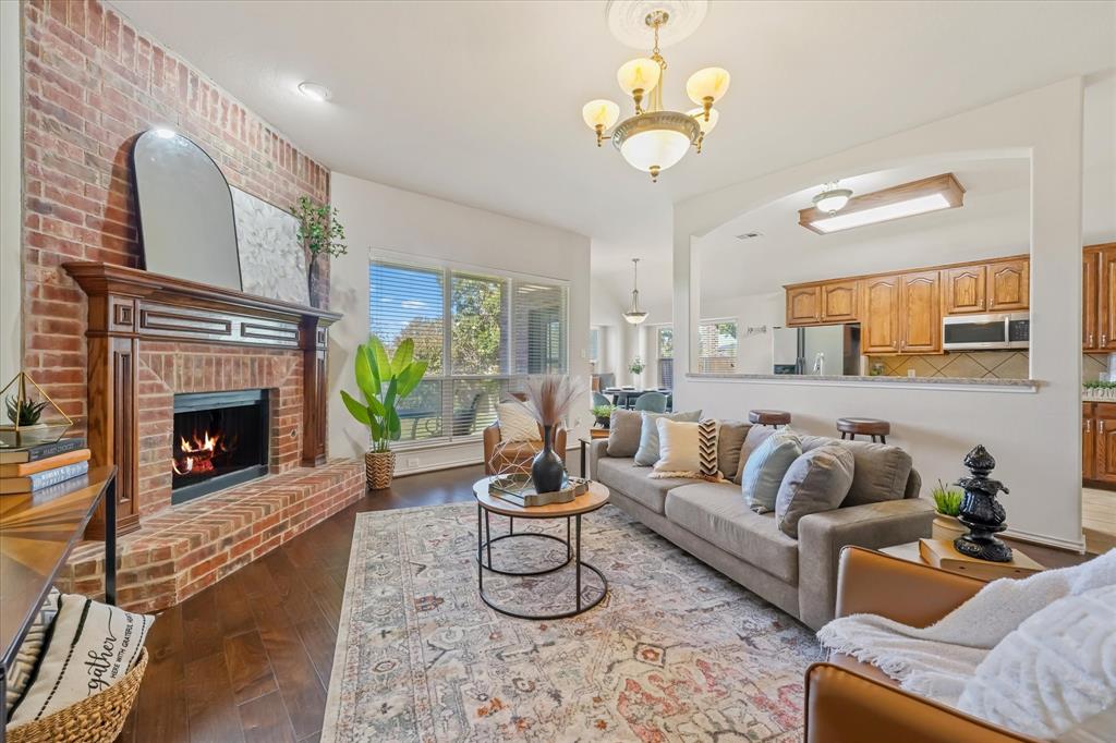 12811 Greenhaven Drive Frisco, TX 75035 - Photo 8 of 28 a living room with furniture and a fireplace