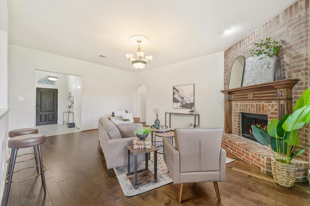 12811 Greenhaven Drive Frisco, TX 75035 - Photo 10 of 28 a living room with furniture a fireplace and wooden floor