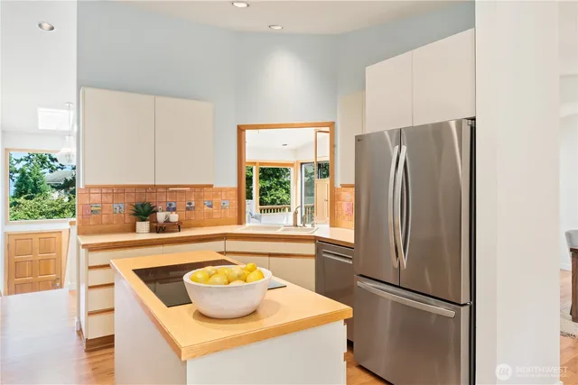 a kitchen with refrigerator and window