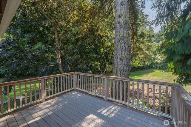 a view of balcony with wooden floor and fence