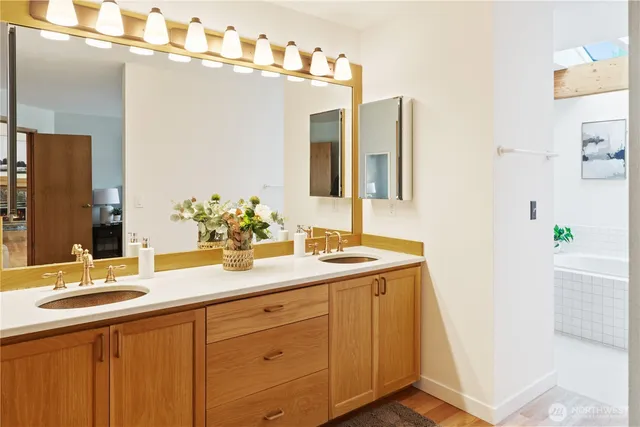 a bathroom with a sink double vanity granite and a mirror