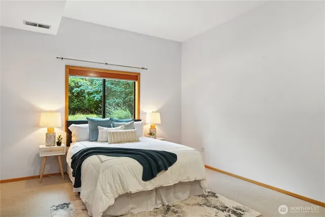 a bedroom with a bed and window