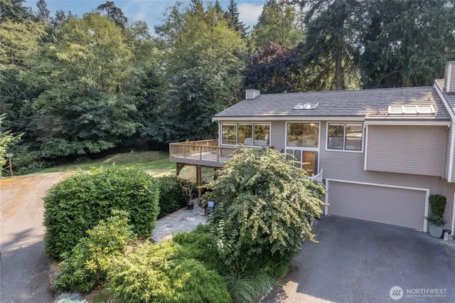 a view of a house with backyard and sitting area