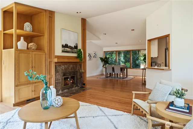 a living room with furniture fireplace and potted plant