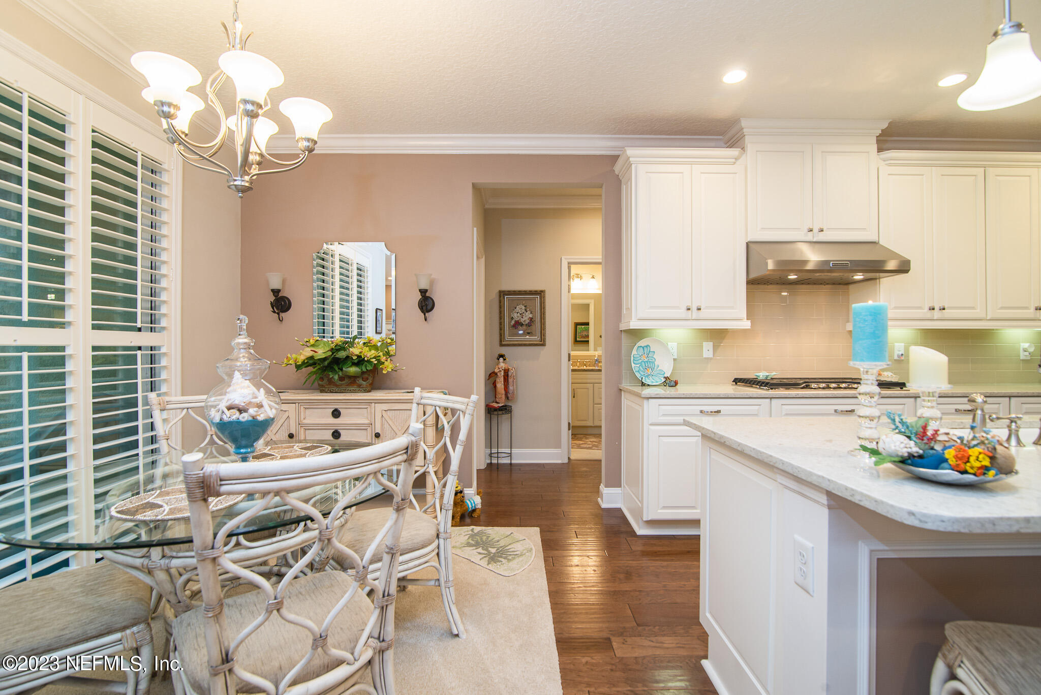 76 Oyster Bay Way Ponte Vedra, FL 32081 - Photo 11 of 28 a kitchen with stainless steel appliances granite countertop a stove a sink dishwasher a dining table and chairs with wooden floor