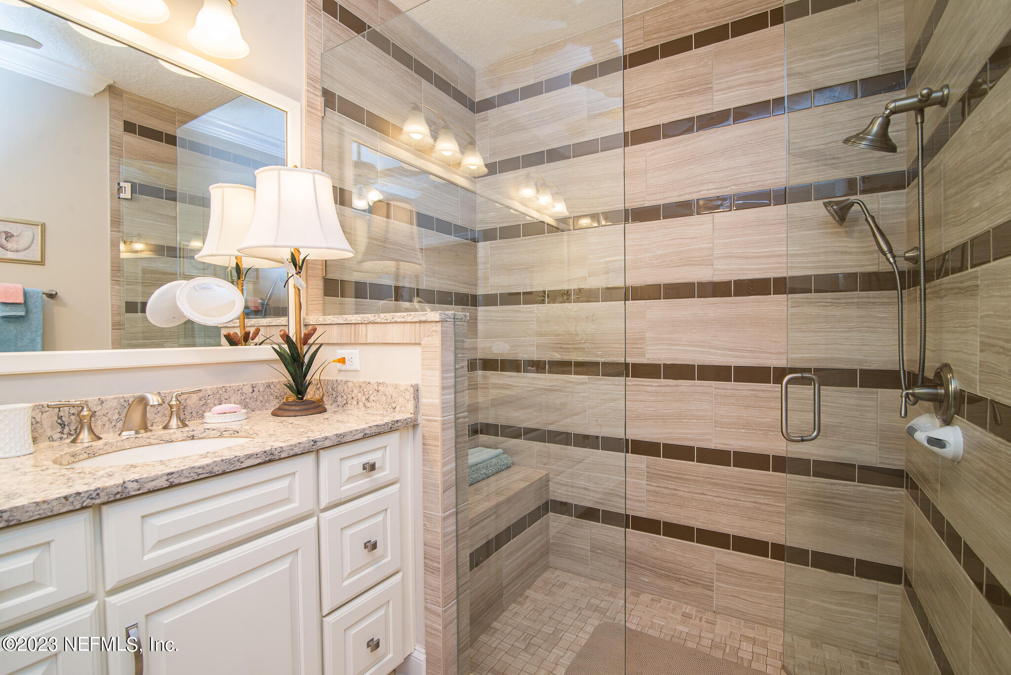76 Oyster Bay Way Ponte Vedra, FL 32081 - Photo 19 of 28 a bathroom with a shower sink and mirror