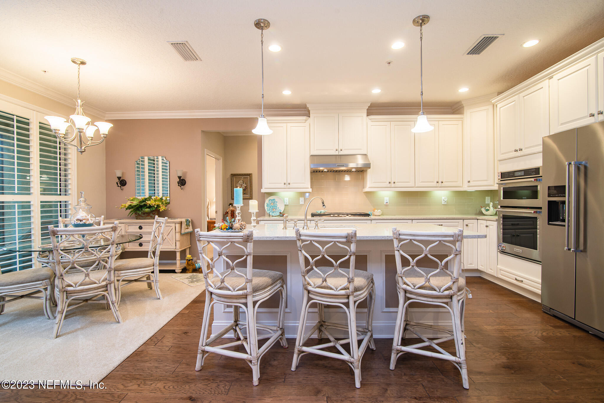 76 Oyster Bay Way Ponte Vedra, FL 32081 - Photo 6 of 28 a dining room with stainless steel appliances kitchen island granite countertop a table chairs and a refrigerator