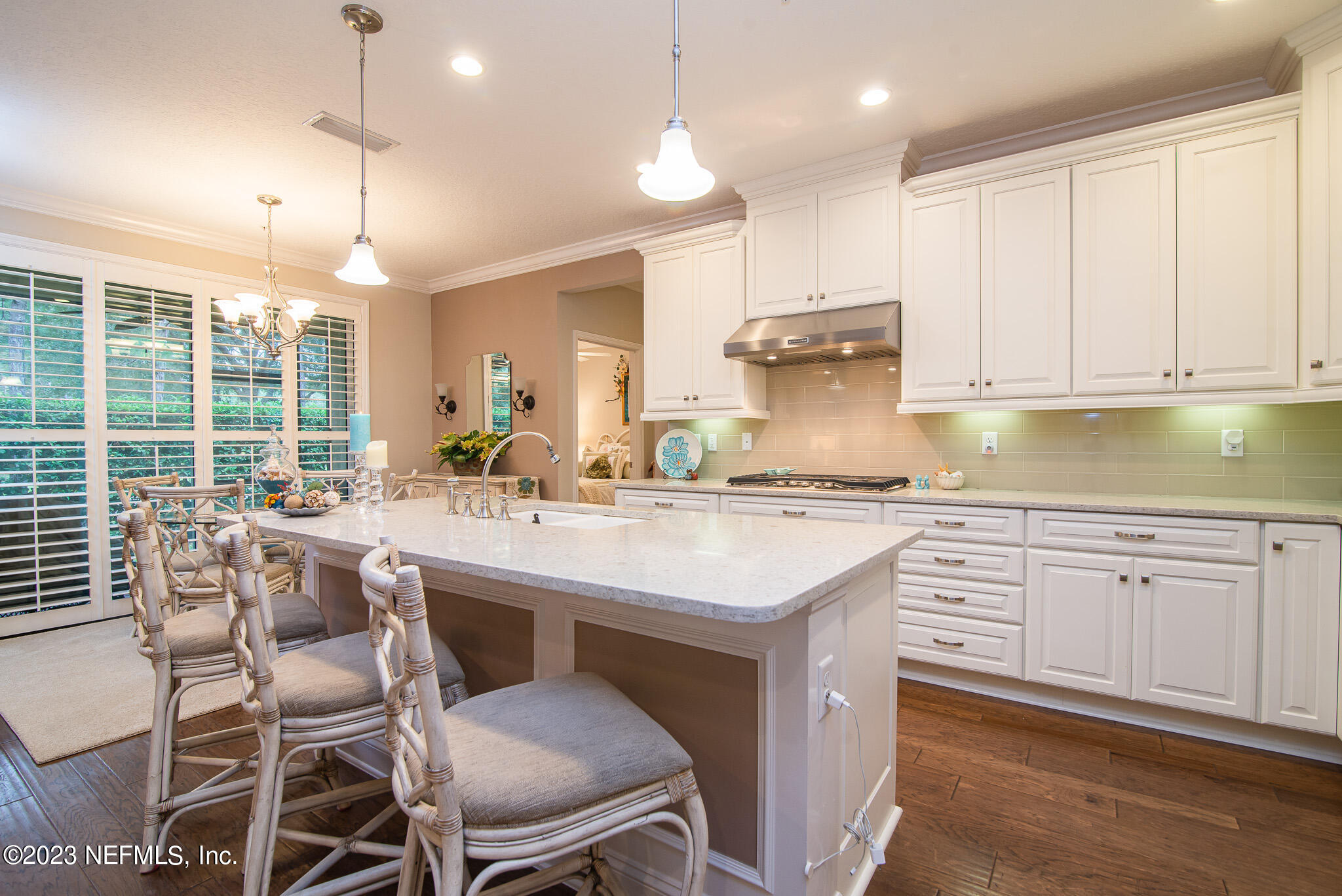 76 Oyster Bay Way Ponte Vedra, FL 32081 - Photo 9 of 28 a kitchen with center island white cabinets and white appliances