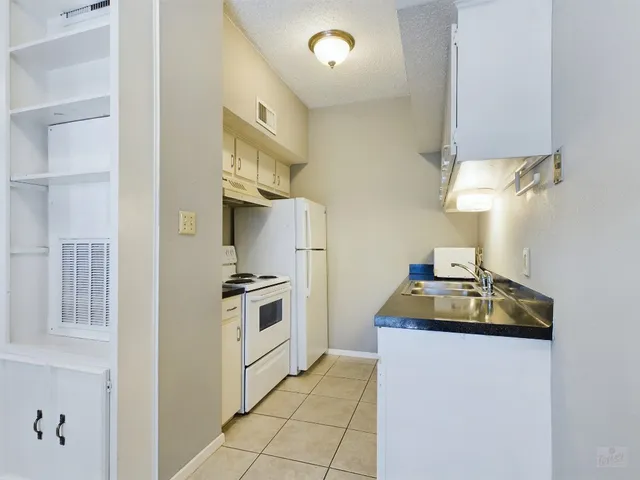 a kitchen with stainless steel appliances white cabinets and a stove