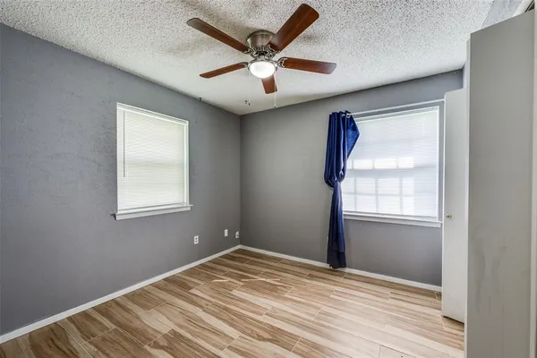 a view of a kitchen with a sink and refrigerator