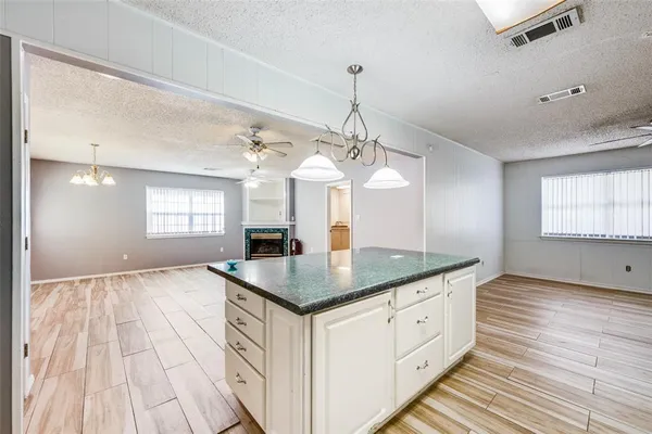 a view of kitchen with stainless steel appliances refrigerator stove microwave and cabinets