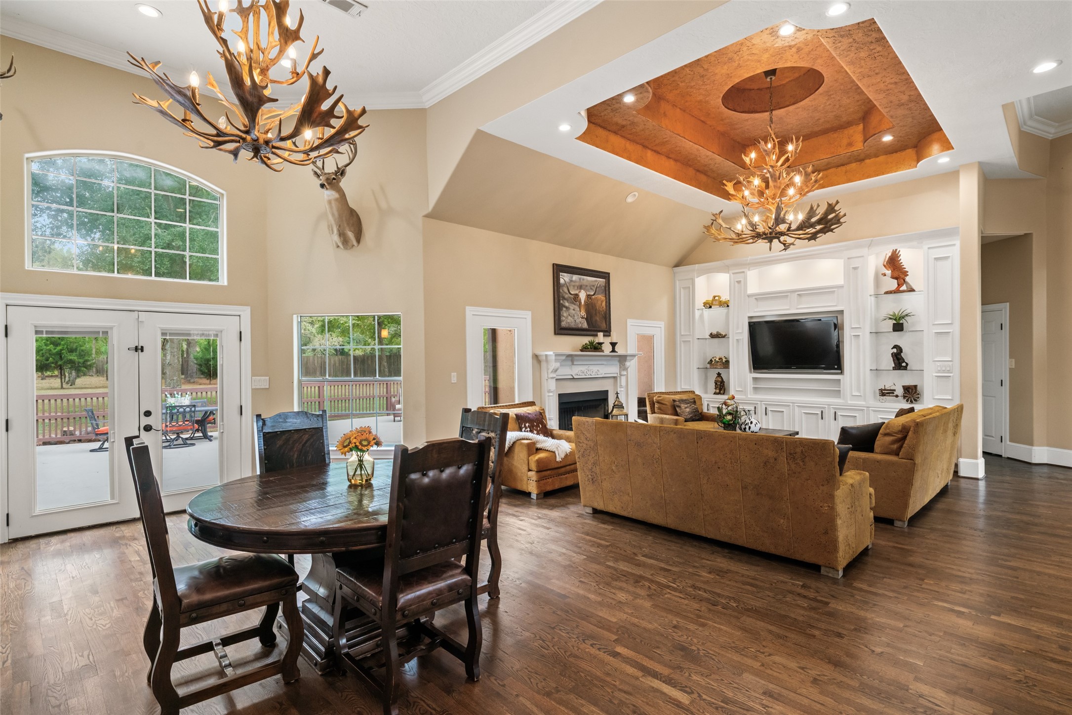 32660 Willow Bend Road Waller, TX 77484 - Photo 8 of 47 Dining and living areas connect effortlessly beneath high ceilings with expansive windows providing plenty of natural light.