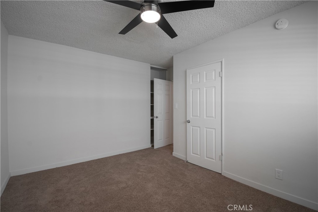 906 East Imperial Avenue El Segundo, CA 90245 - Photo 3 of 21 an empty room with a ceiling fan and carpet