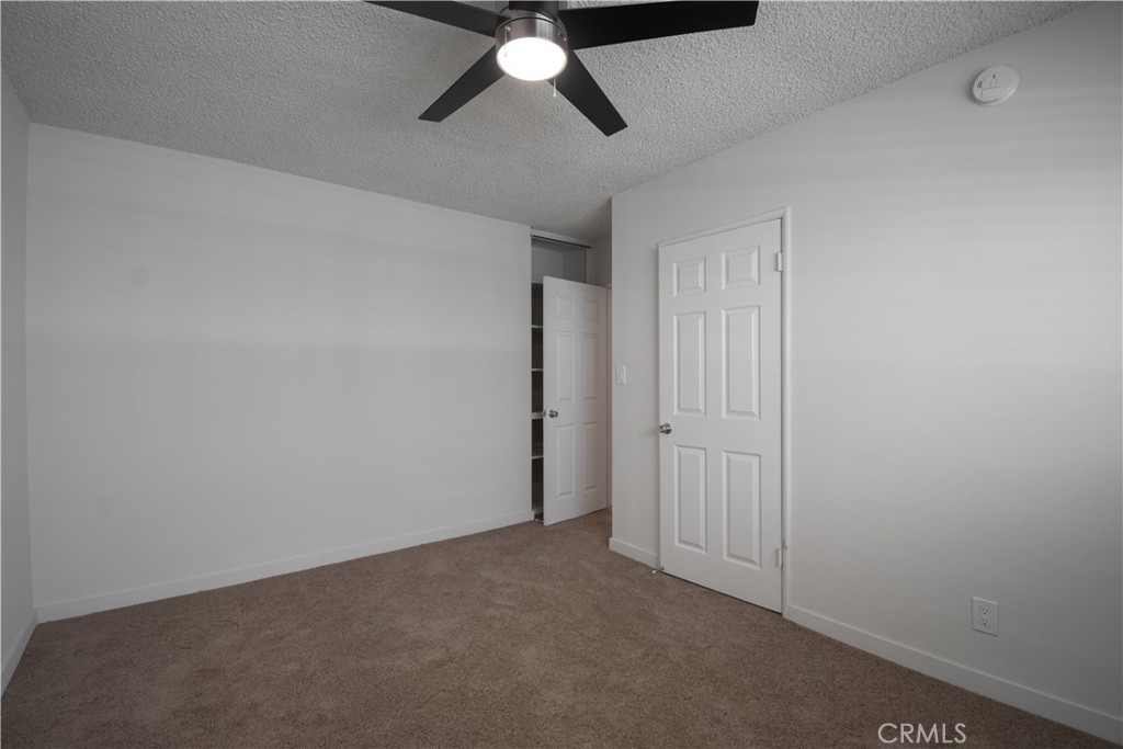 906 East Imperial Avenue El Segundo, CA 90245 - Photo 8 of 21 an empty room with a ceiling fan and carpet