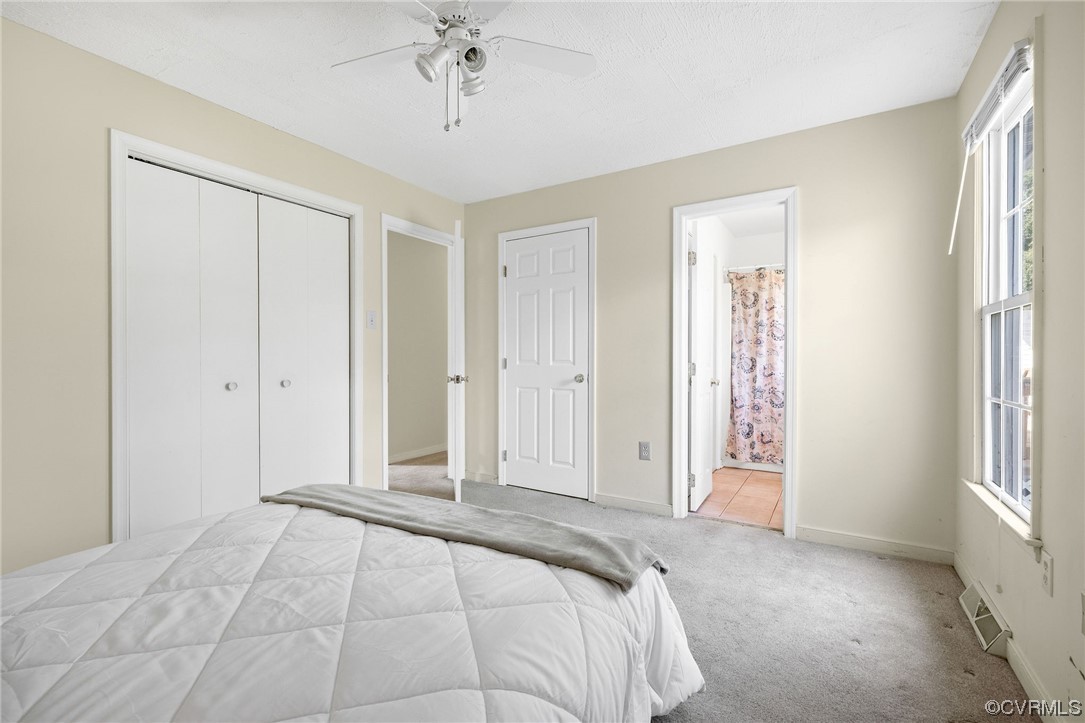 4841 Wilconna Road Chesterfield, VA 23832 - Photo 25 of 34 a view of a bedroom with a chandelier fan and closet in a room