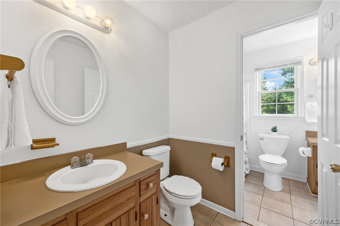 4841 Wilconna Road Chesterfield, VA 23832 - Photo 26 of 34 a bathroom with a granite countertop toilet a sink and a mirror