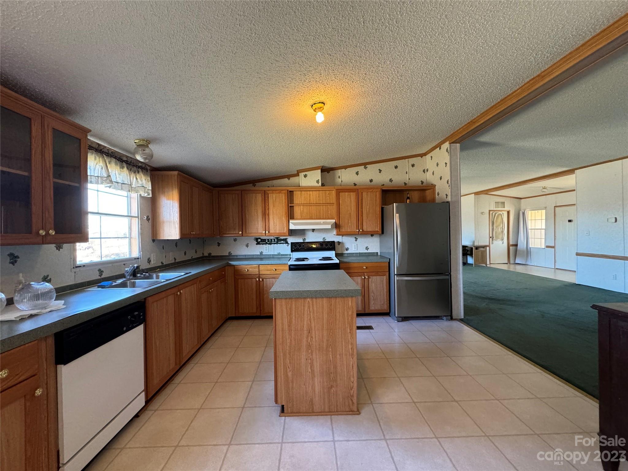 648 Ike Lynch Road Dallas, NC 28034 - Photo 11 of 32 a kitchen with stainless steel appliances granite countertop a sink counter space cabinets and a large window