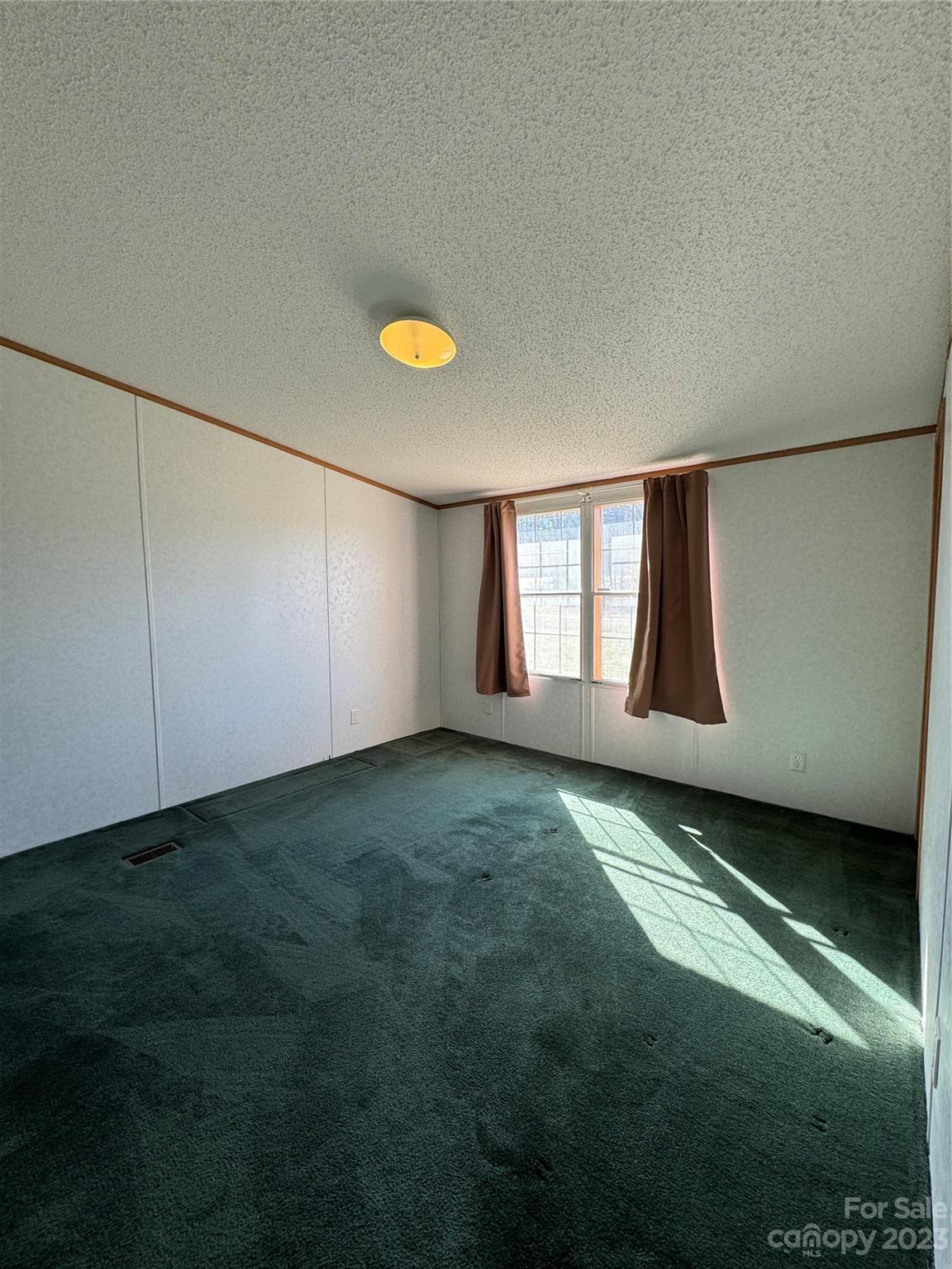 648 Ike Lynch Road Dallas, NC 28034 - Photo 21 of 32 a view of an empty room with window and stairs