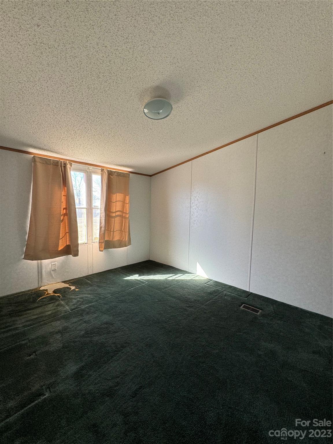 648 Ike Lynch Road Dallas, NC 28034 - Photo 23 of 32 a view of an empty room with window and hardwood floor
