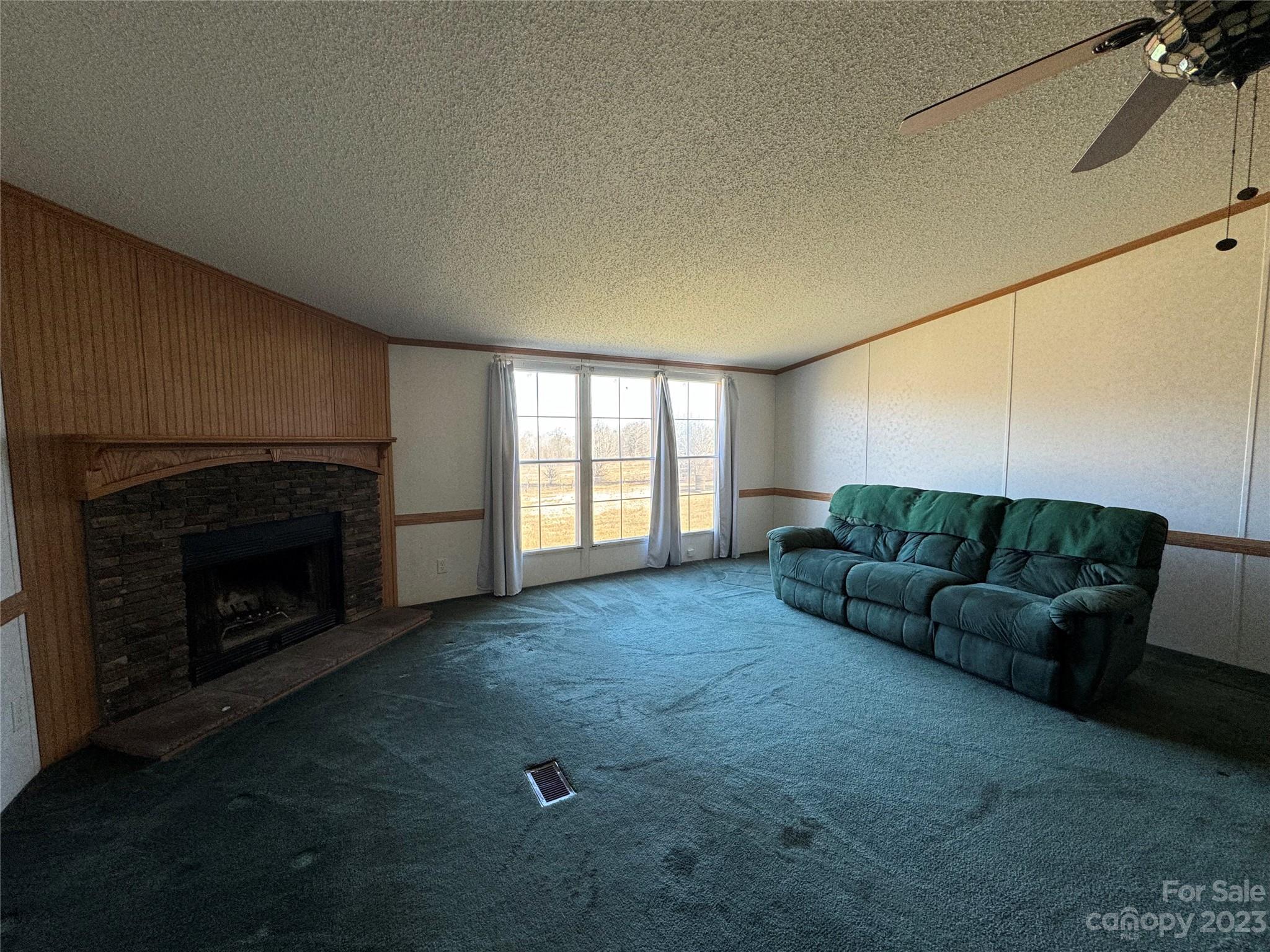 648 Ike Lynch Road Dallas, NC 28034 - Photo 5 of 32 a living room with furniture and a fireplace
