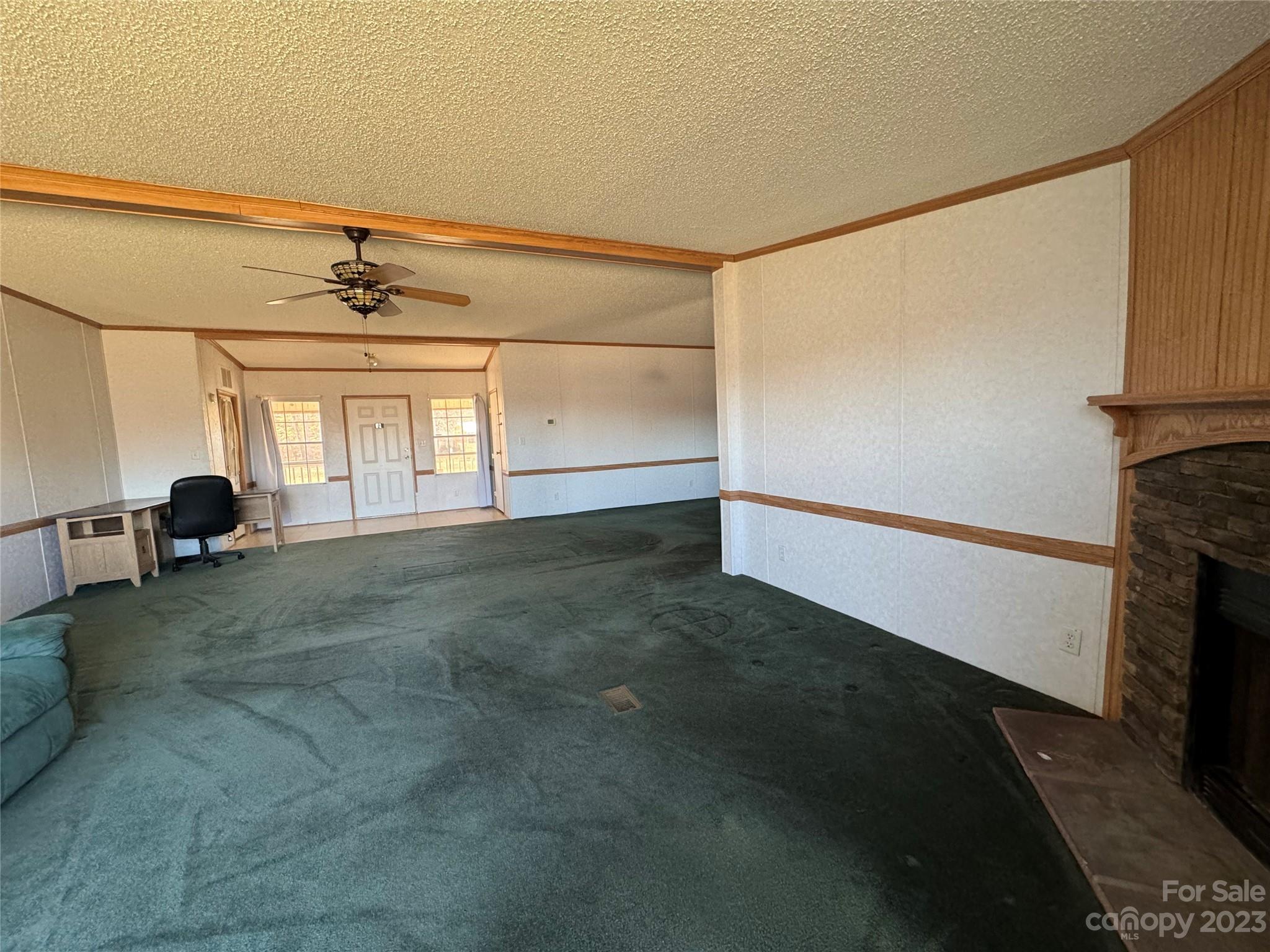 648 Ike Lynch Road Dallas, NC 28034 - Photo 6 of 32 a view of empty room with wooden floor and fan