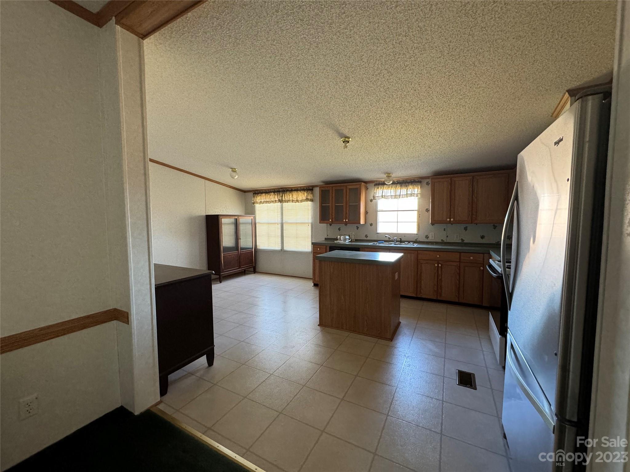 648 Ike Lynch Road Dallas, NC 28034 - Photo 9 of 32 a kitchen with stainless steel appliances a refrigerator and a sink