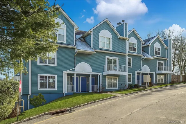 a front view of a residential apartment building with a yard