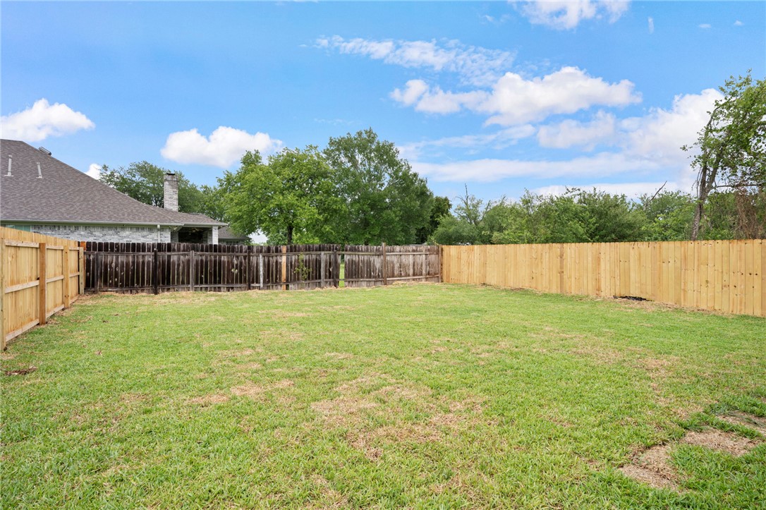 505 Legion Court Bryan, TX 77803 - Photo 18 of 21 a view of a backyard with a garden and entertaining space