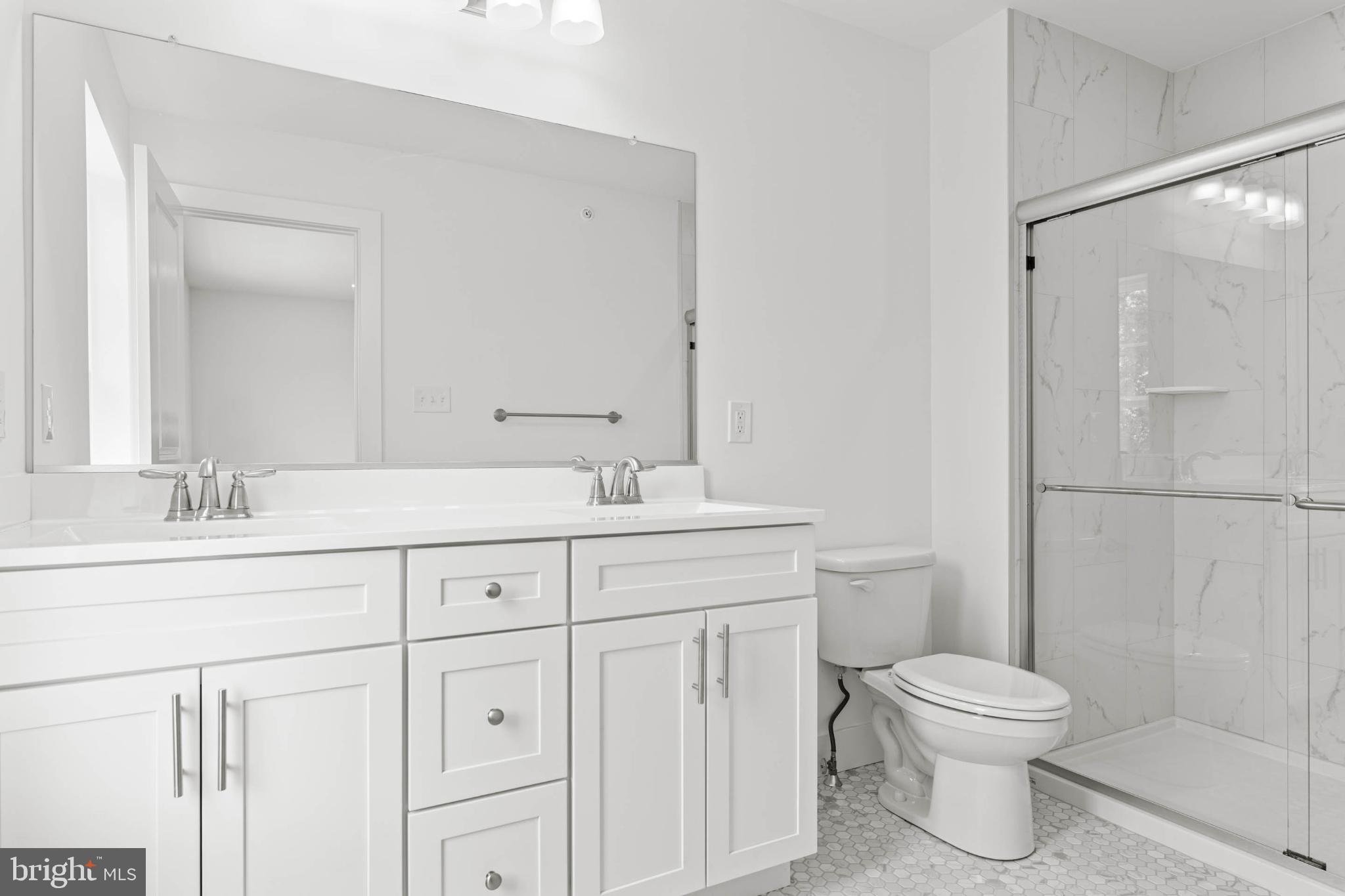 207 8th Street Bridgeport, PA 19405 - Photo 7 of 12 Sleek, modern bathroom with elegant finishes.