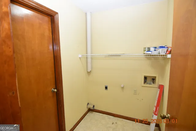 a view of closet with wooden floor