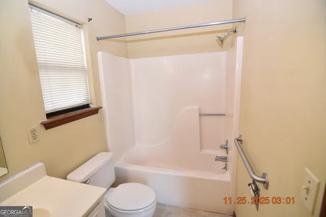 a bathroom with a toilet a sink and a bathtub
