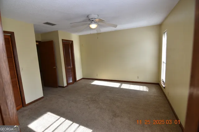 a view of an empty room with a fireplace
