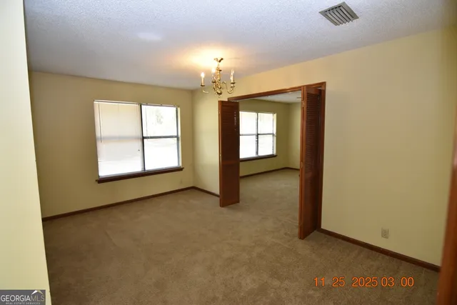 an empty room with windows and entrance