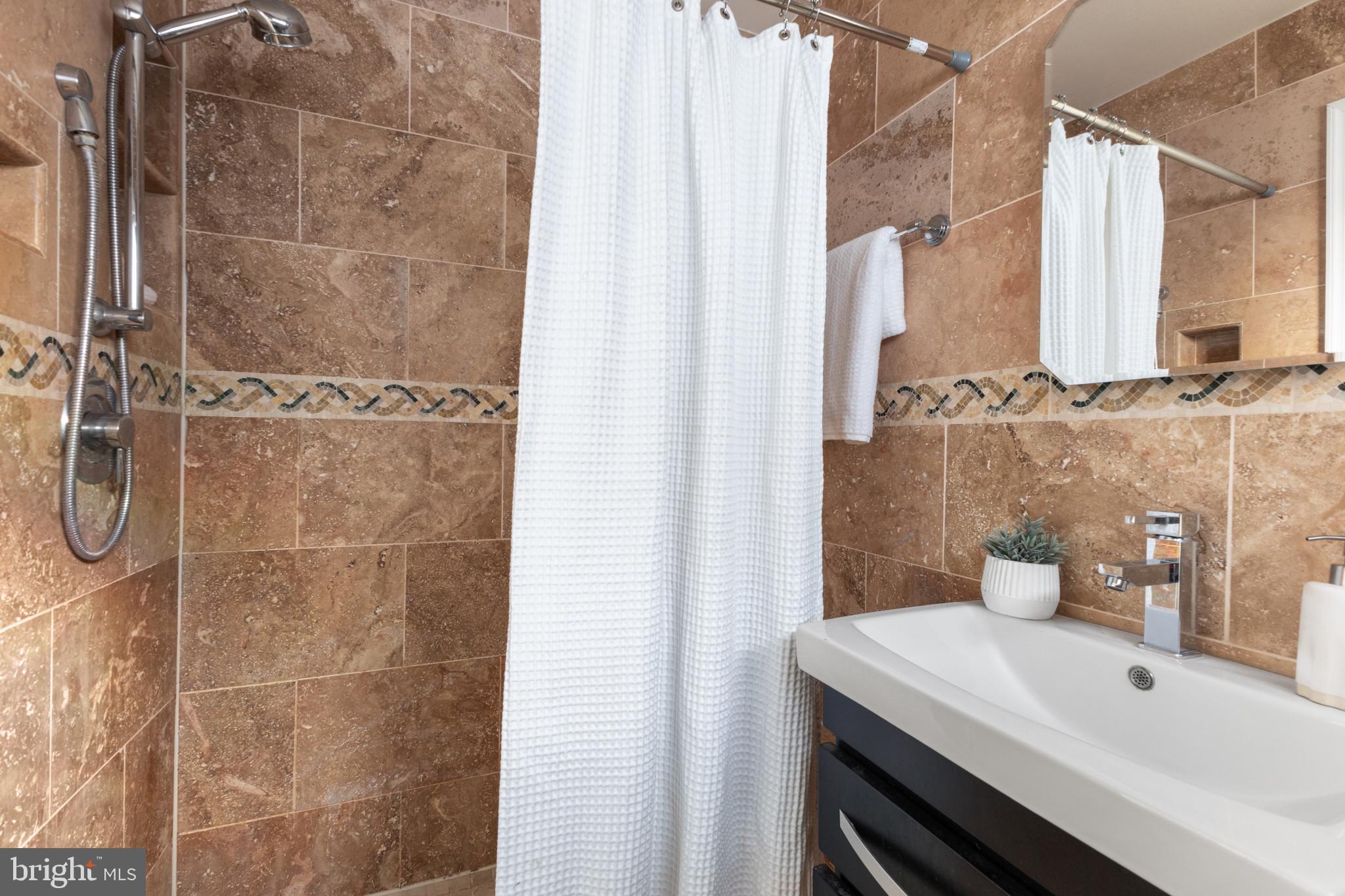 5400 27th Road North Arlington, VA 22207 - Photo 13 of 26 a bathroom with a sink and mirror