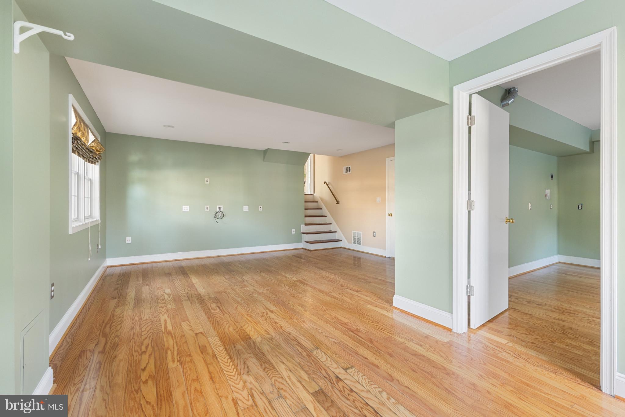 5400 27th Road North Arlington, VA 22207 - Photo 20 of 26 a view of an empty room with wooden floor and a window