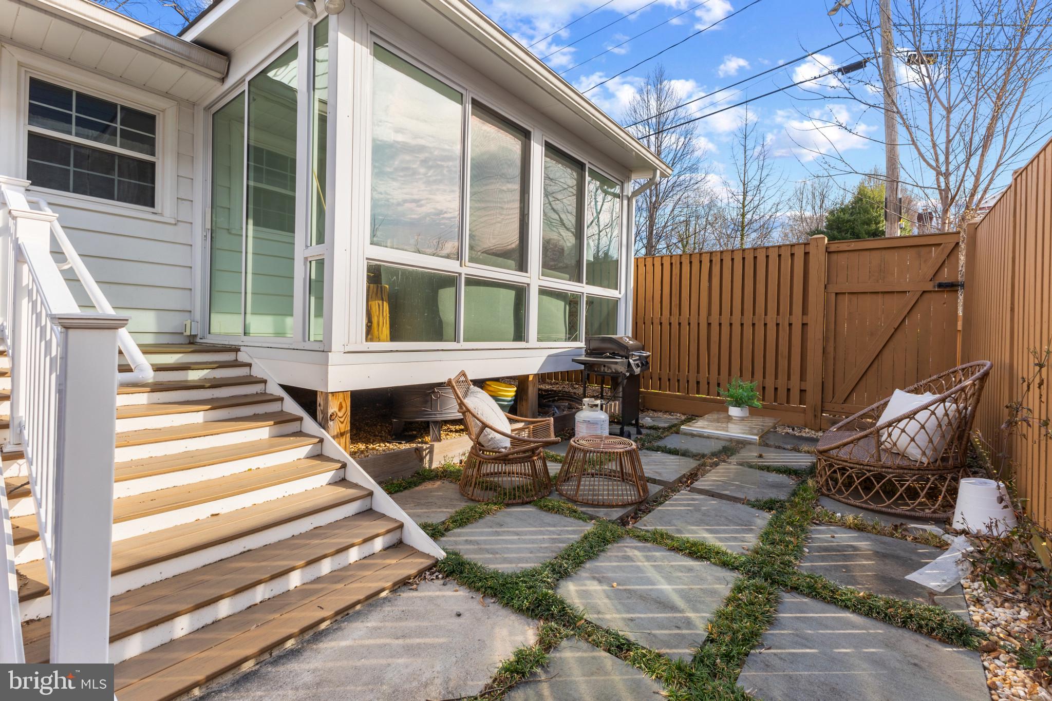 5400 27th Road North Arlington, VA 22207 - Photo 22 of 26 a view of a patio with table and chairs with wooden floor and fence