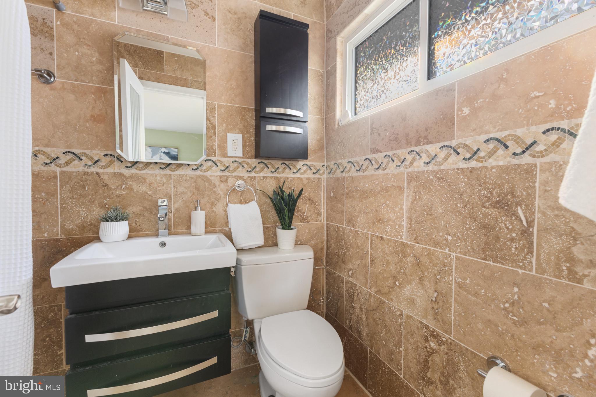 5400 27th Road North Arlington, VA 22207 - Photo 3 of 26 a bathroom with a sink a toilet and a mirror