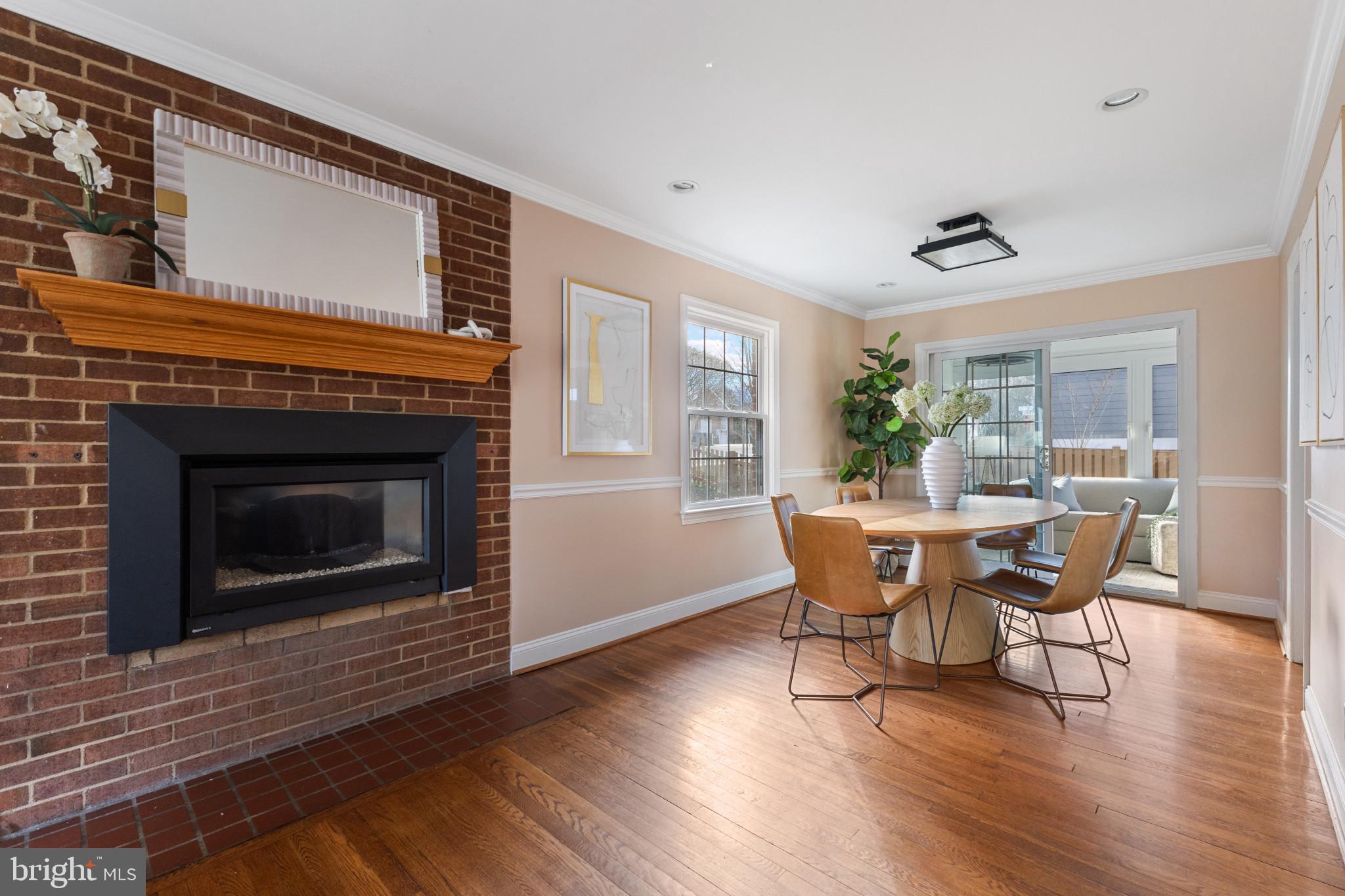 5400 27th Road North Arlington, VA 22207 - Photo 7 of 26 a dining room with furniture a fireplace and wooden floor