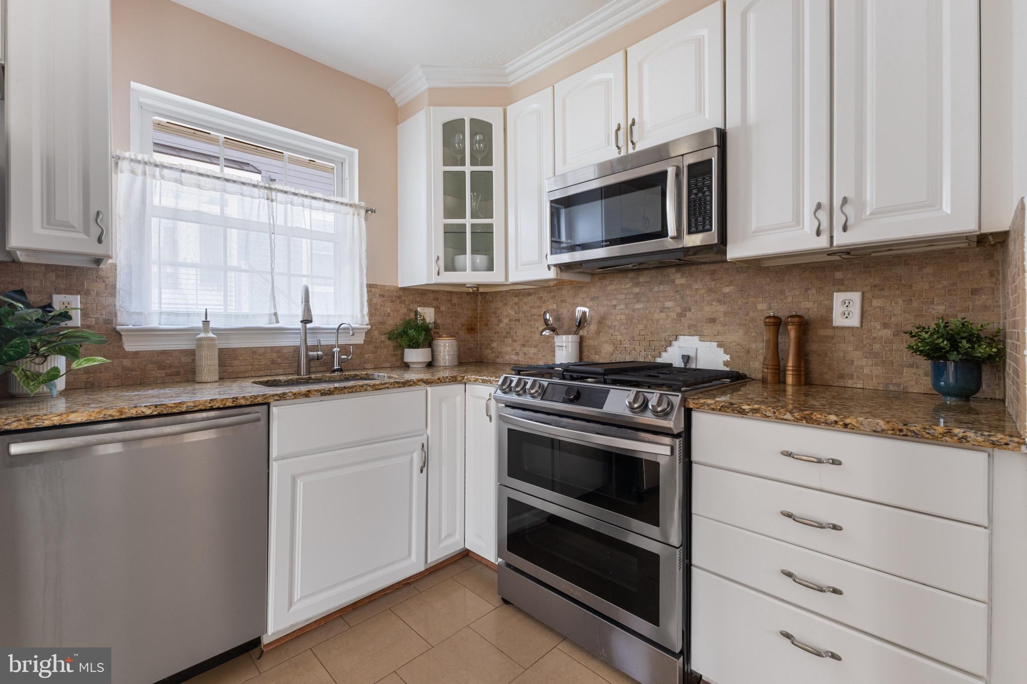 5400 27th Road North Arlington, VA 22207 - Photo 10 of 26 a kitchen with granite countertop white cabinets and appliances