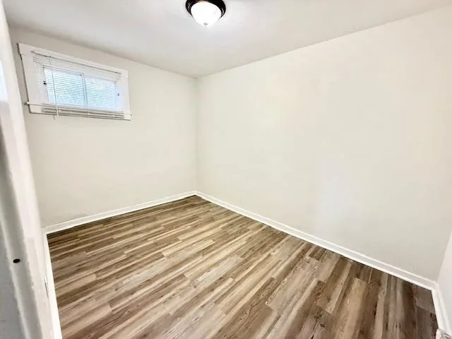 a view of a room with wooden floor