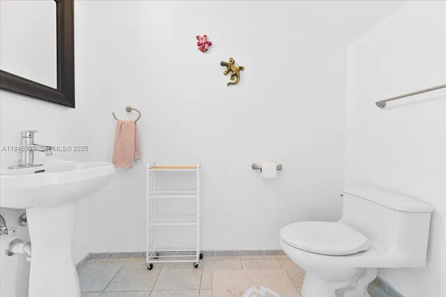 a bathroom with a sink mirror and toilet