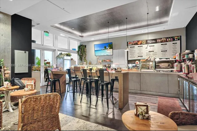 a living room with lots of furniture and a large window