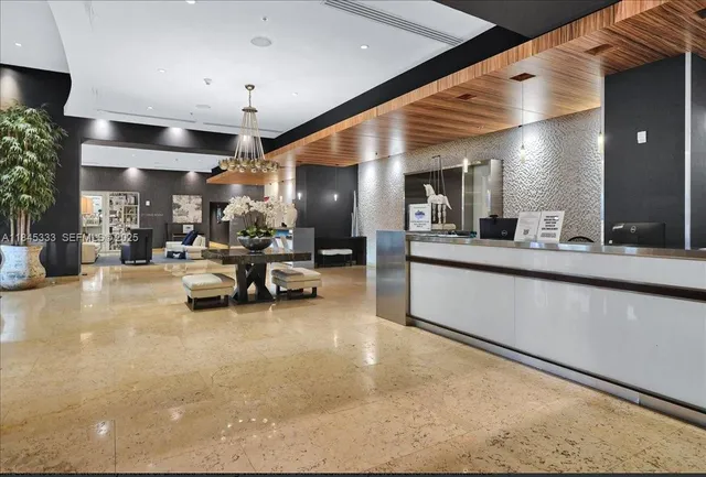 a living room with furniture and kitchen view