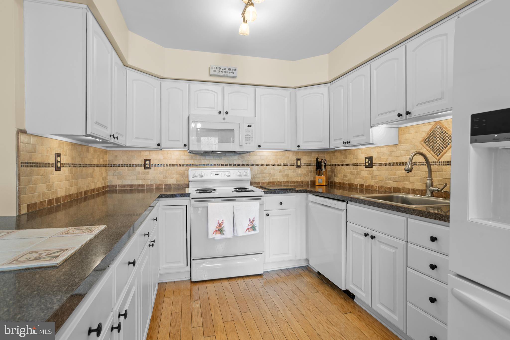 326 Westbriar Drive Media, PA 19063 - Photo 13 of 29 a kitchen with granite countertop white cabinets and white appliances