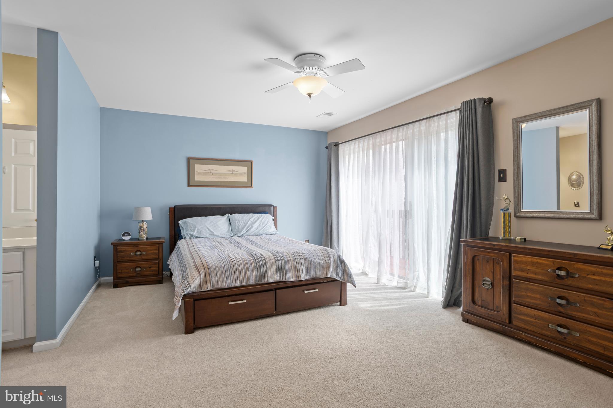 326 Westbriar Drive Media, PA 19063 - Photo 18 of 29 a spacious bedroom with a bed and a chandelier