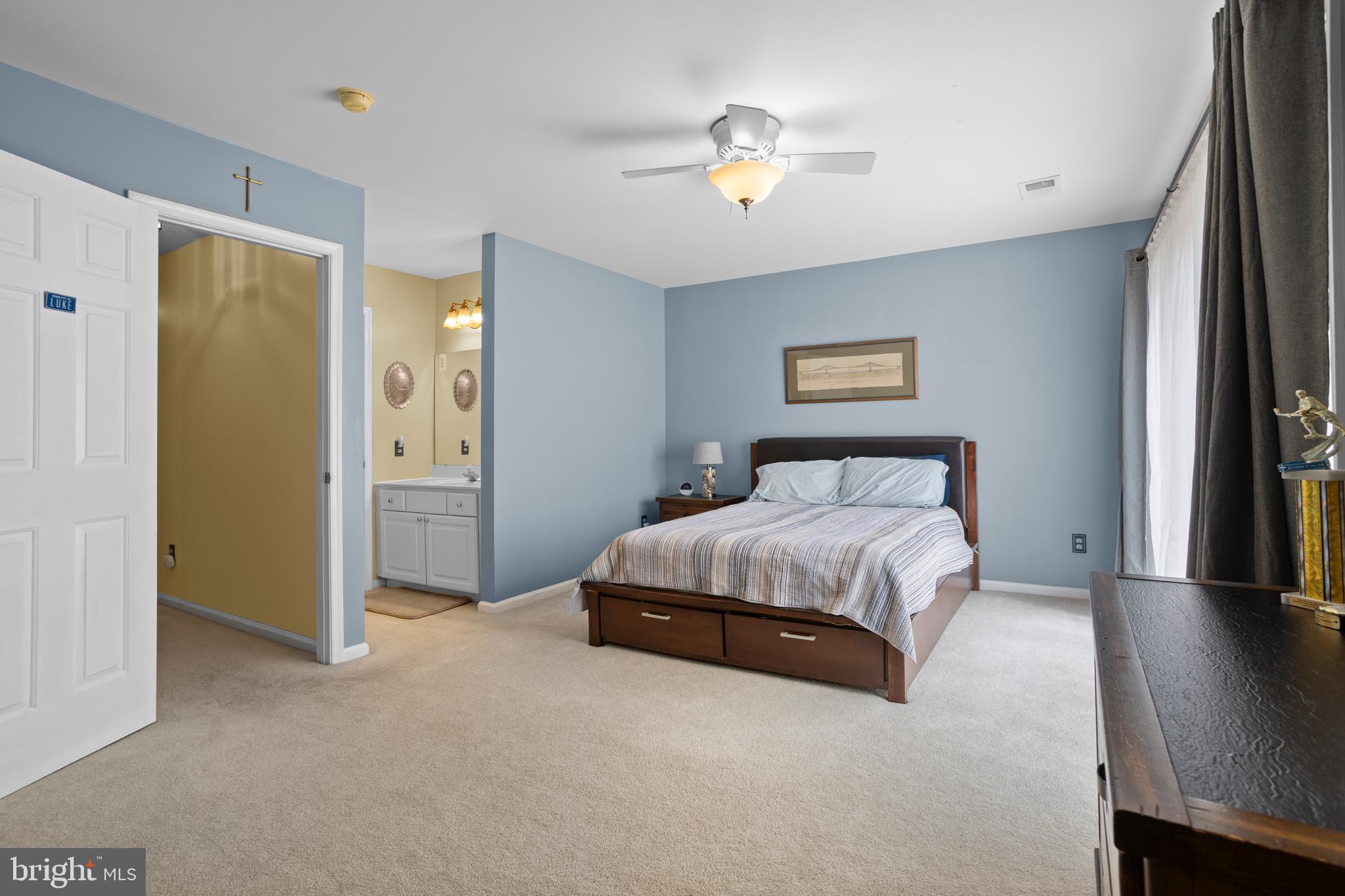326 Westbriar Drive Media, PA 19063 - Photo 19 of 29 a spacious bedroom with a bed and a chandelier