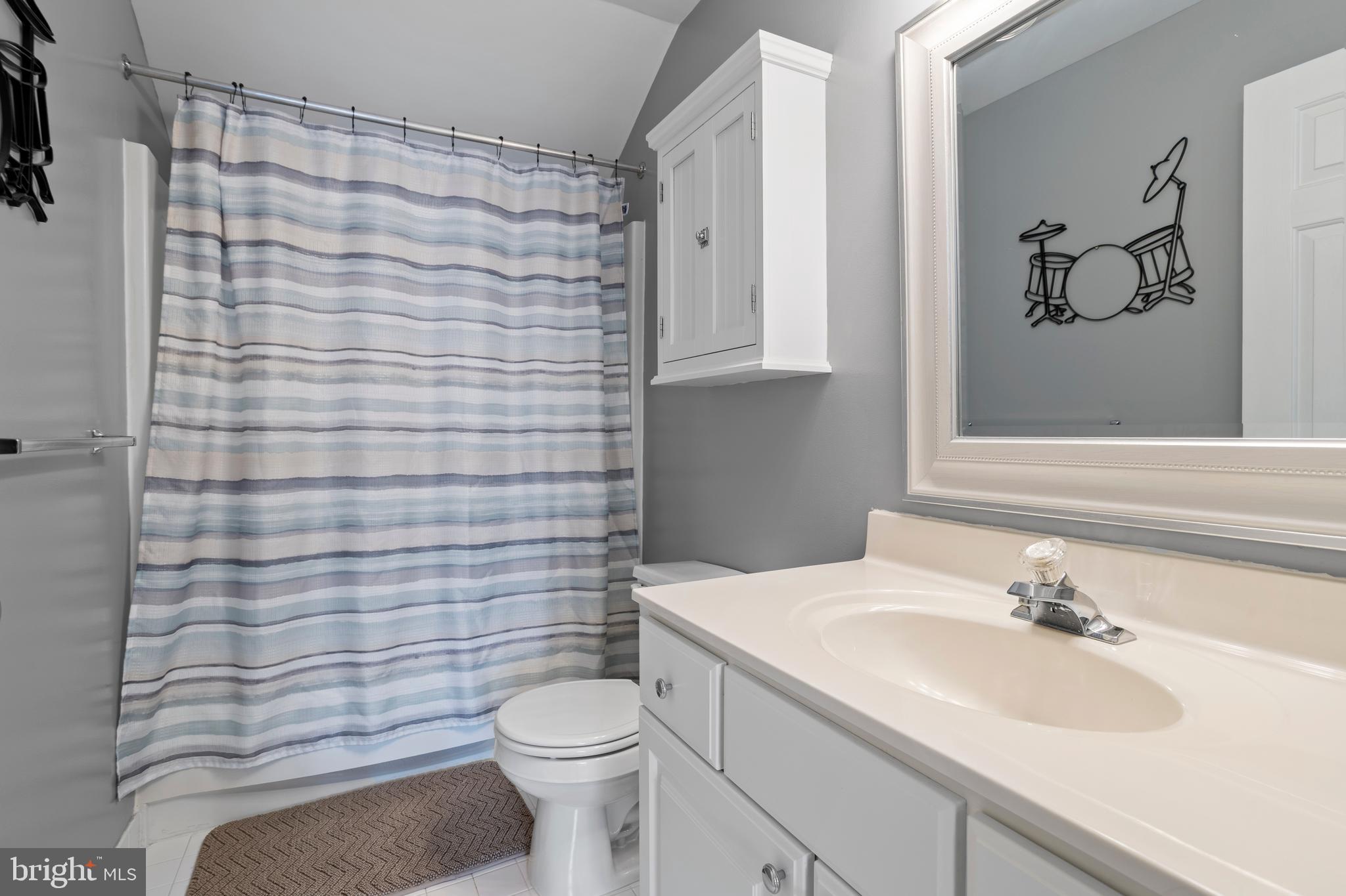 326 Westbriar Drive Media, PA 19063 - Photo 24 of 29 a bathroom with a sink a toilet and shower curtain